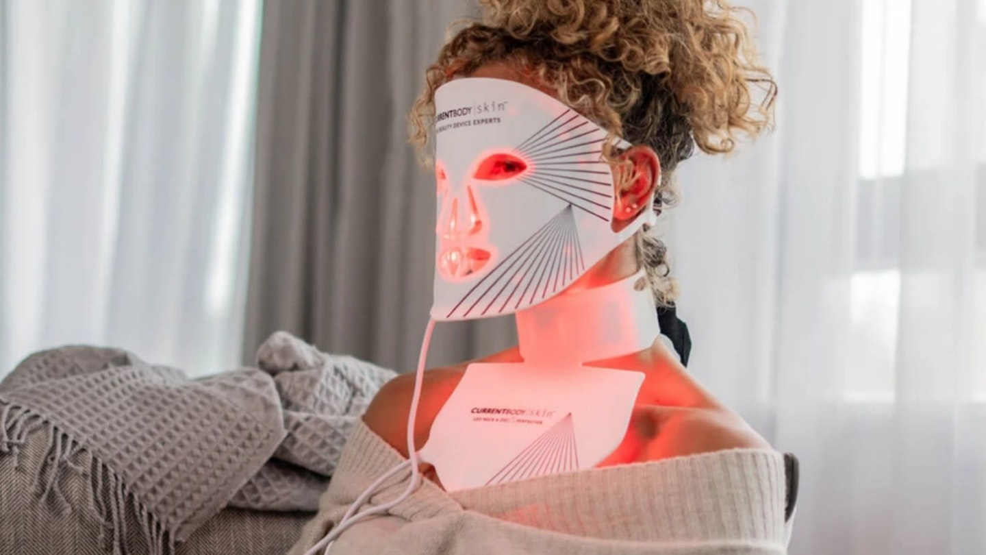 Woman using a LED face mask at home