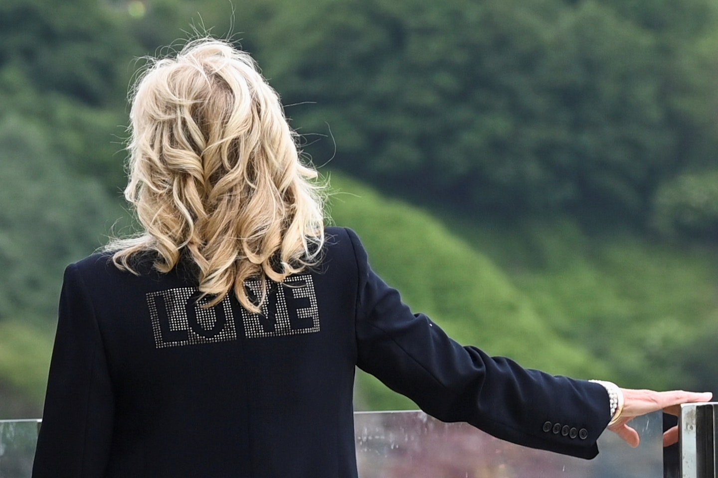 Jill Biden wearing a black jacket with the word 'Love' on the back 