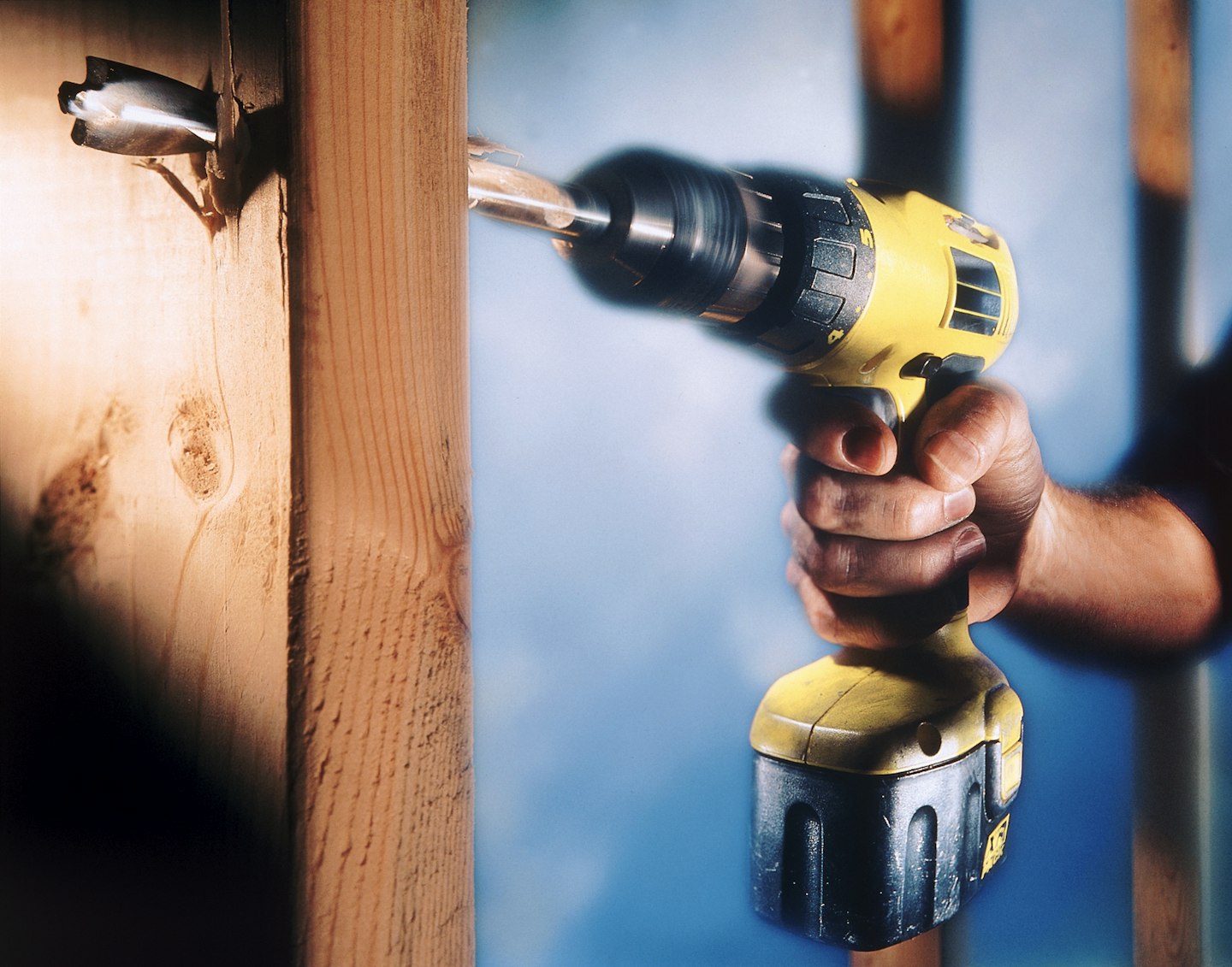 cordless drill drilling into wood