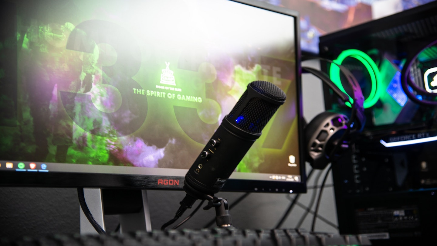 A picture of a microphone in front of a gaming setup