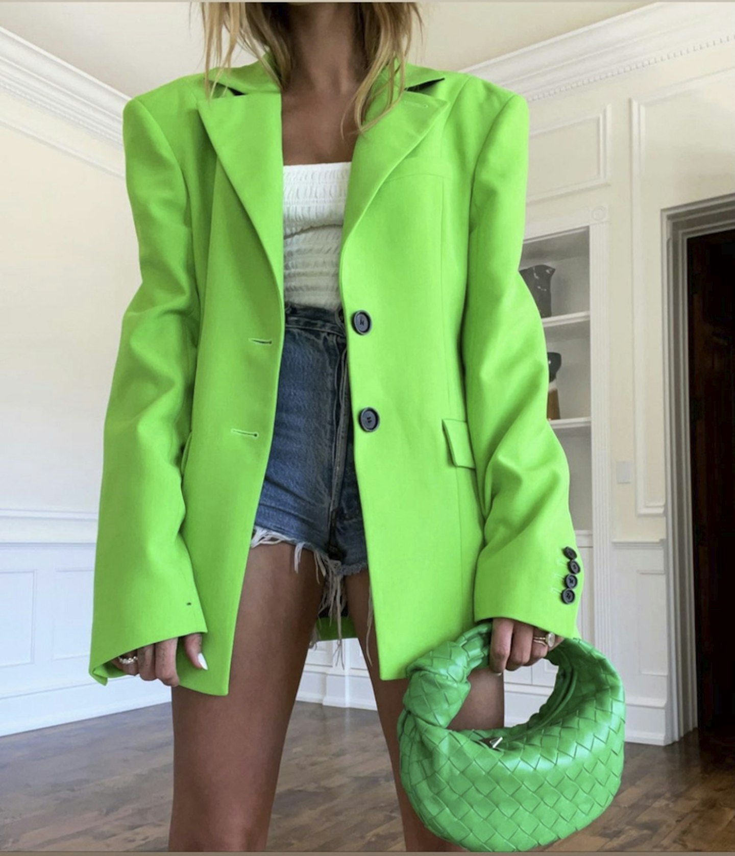 hailey bieber wearing green blazer denim shorts 