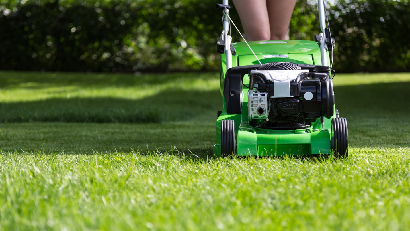 Woman pushing lawnmower