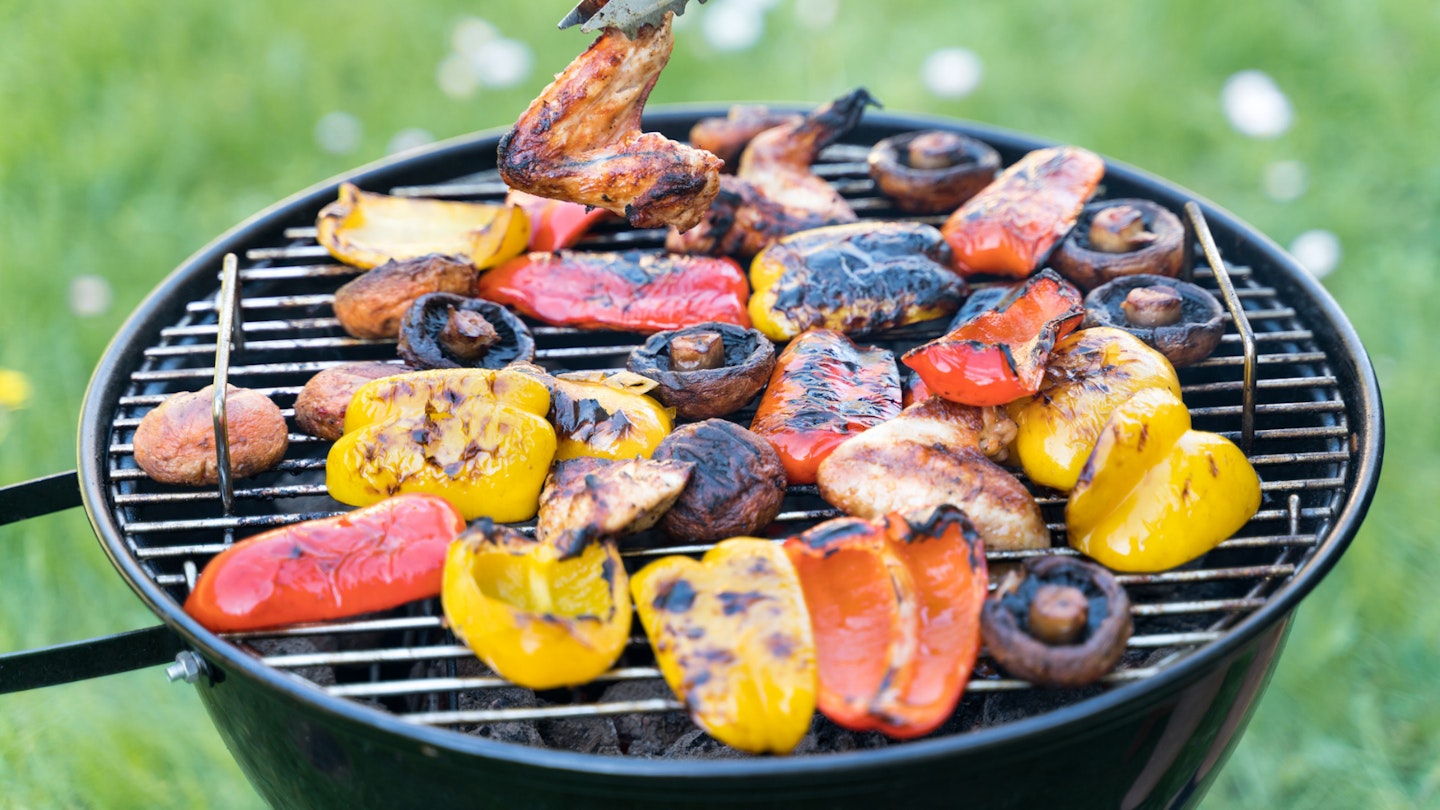 Veggies and meat on charcoal BBQ