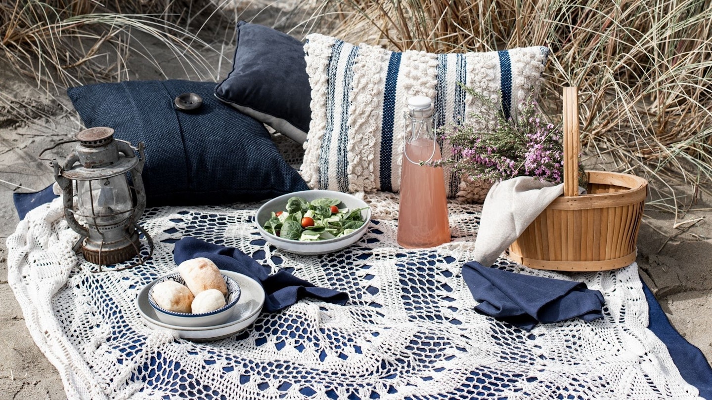 Picnicware and blanket set-up on the beach