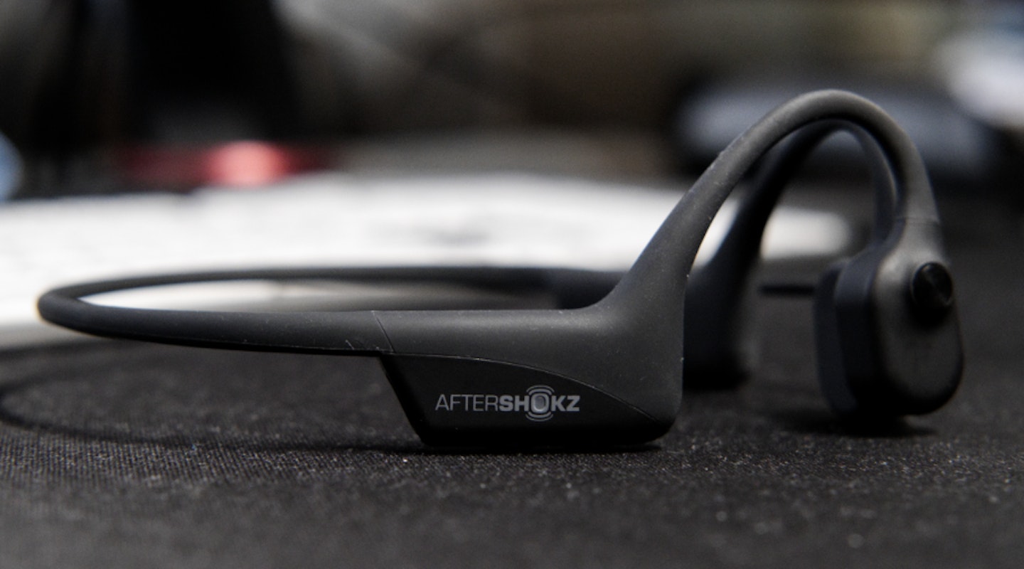 AfterShokz OpenComm Headset on desk, logo view