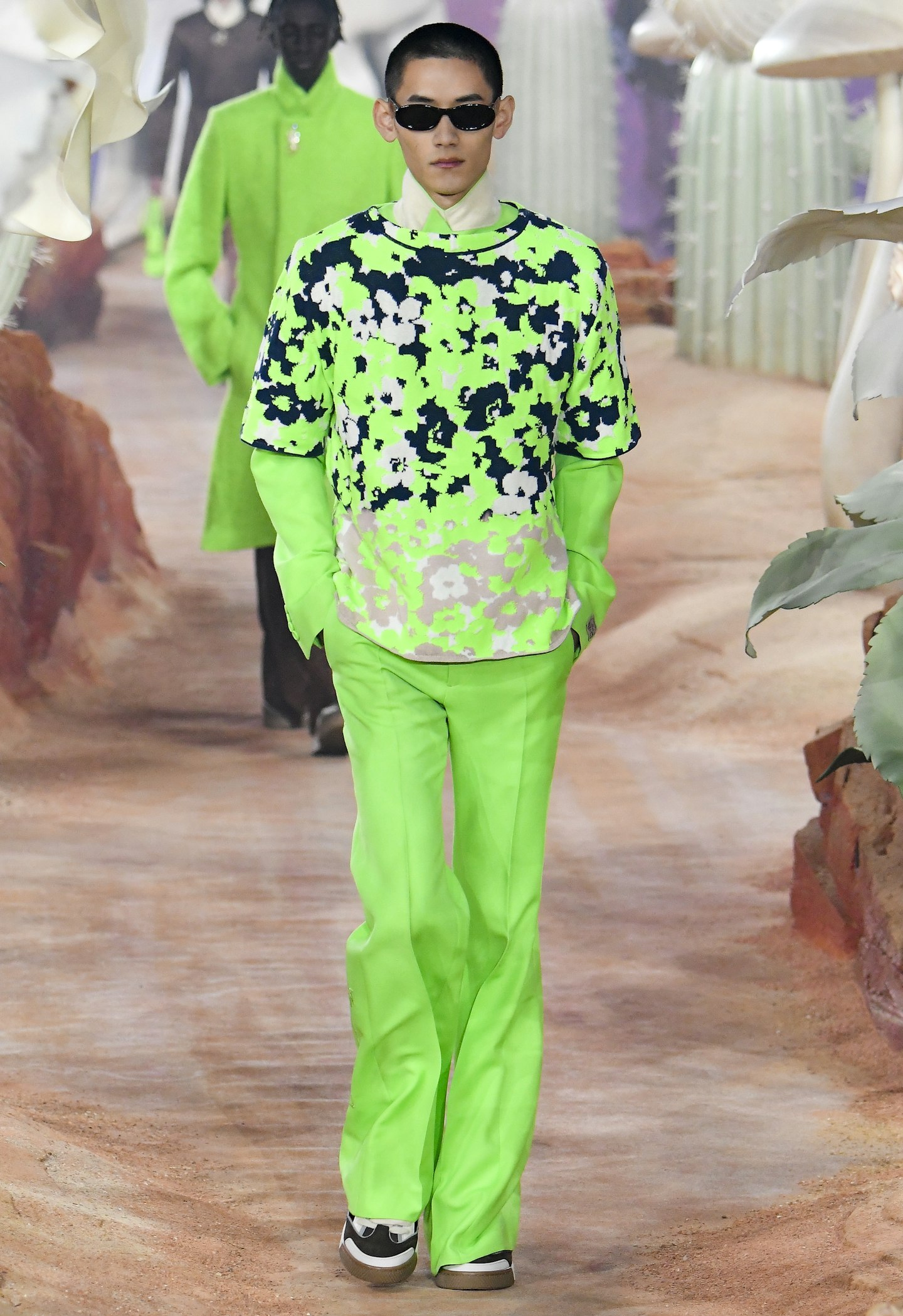 A model wearing a neon green outfit at Dior 