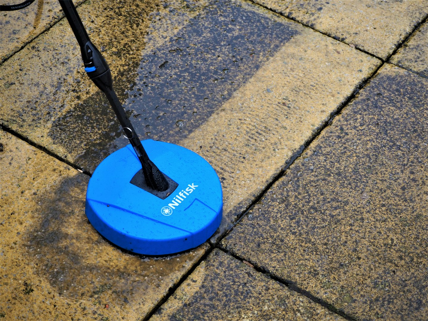Nilfisk patio cleaner attachment cleaning a patio