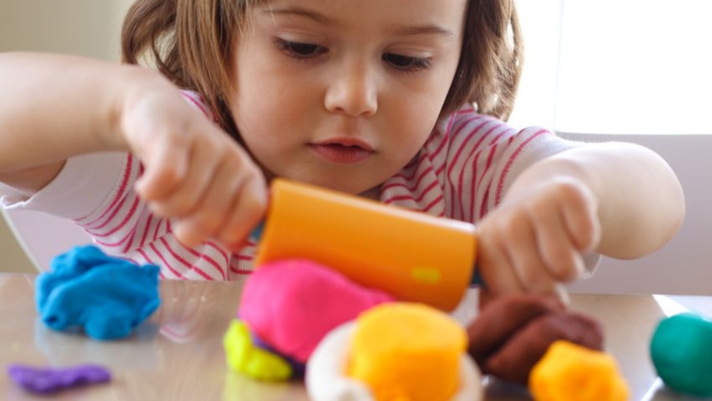 Kid playing with playdough