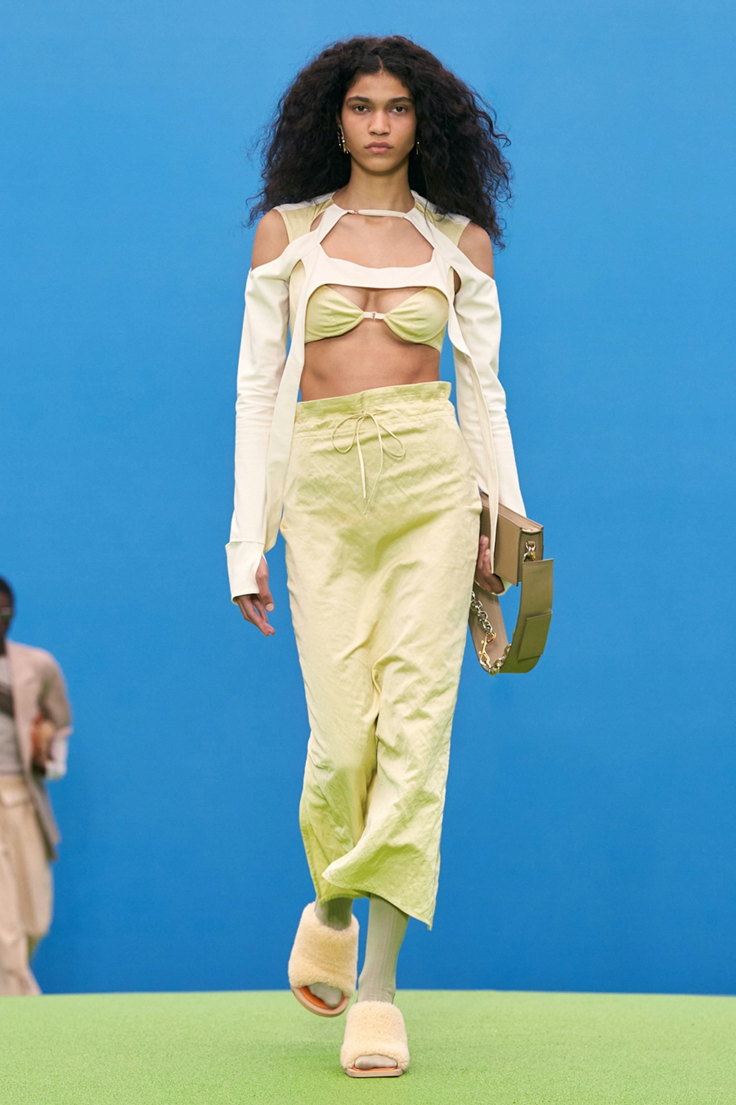 A model wearing a light green outfit at Jacquemus 