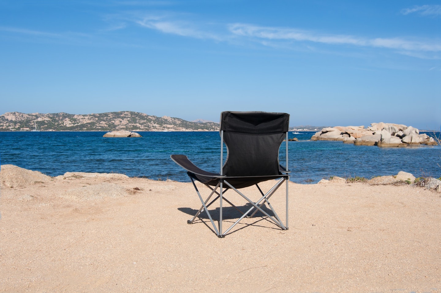 an empty camping chair overlooking the sea