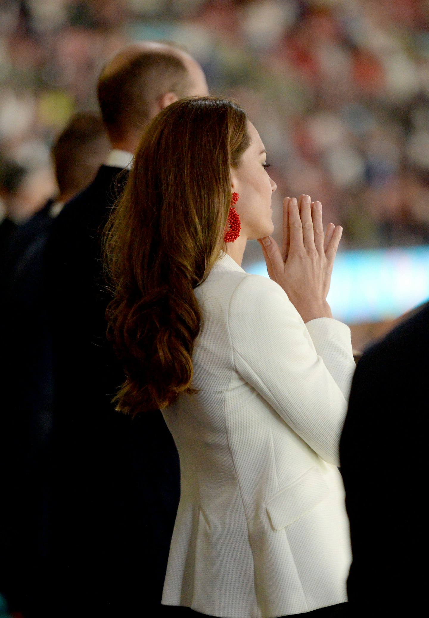 Kate Middleton watching the football final wearing red earrings and a white blazer 