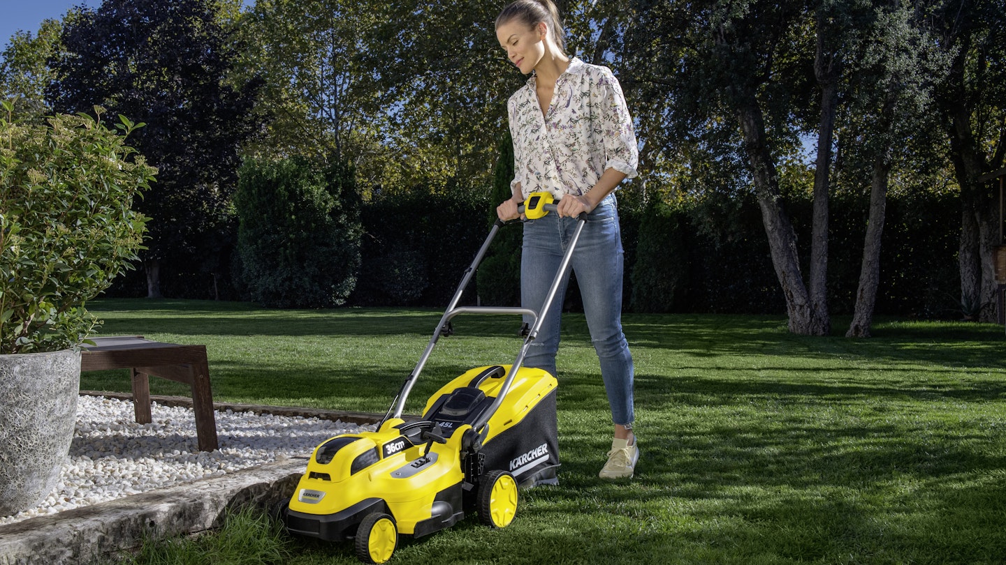 Woman mowing lawn using Kärcher cordless mower LMO 18-36
