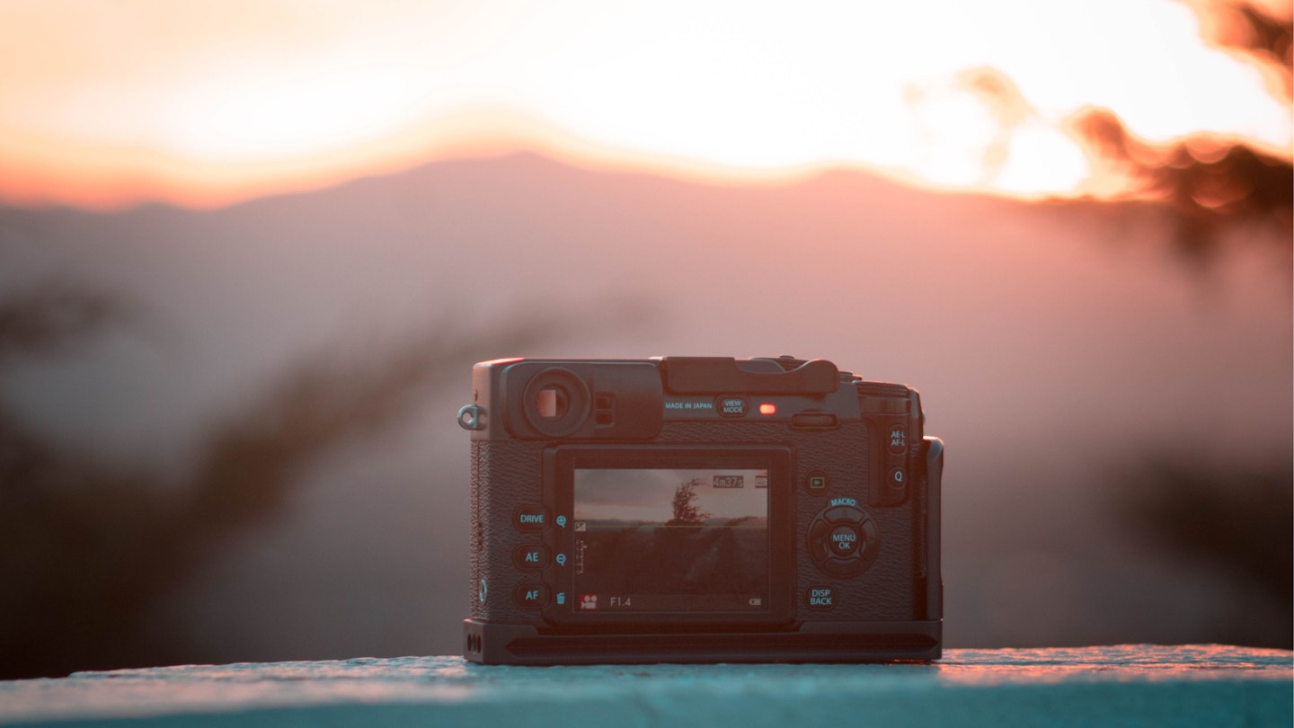 A camera facing a landscape sunset