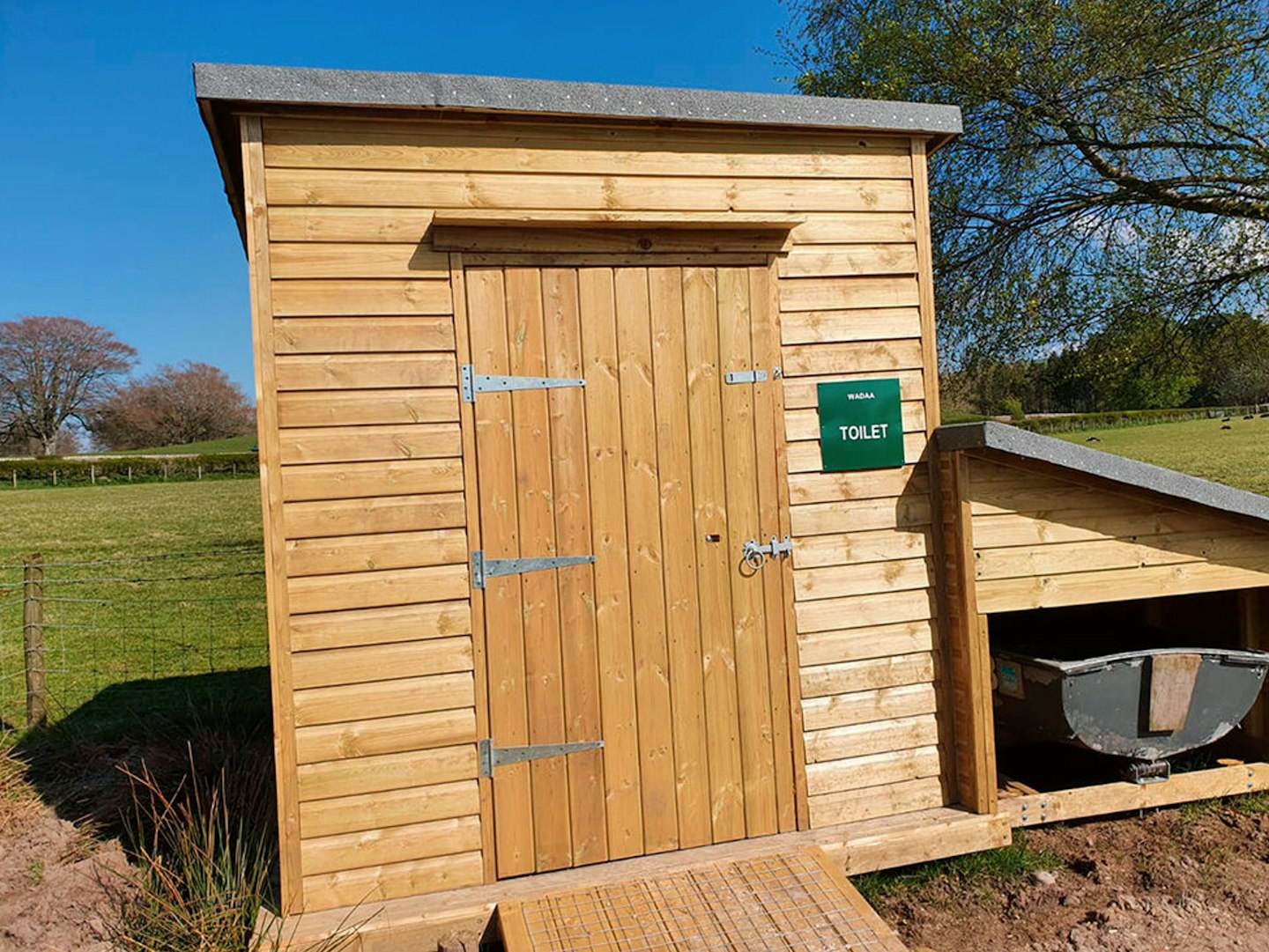 Its compostable loos are basic wooden sheds with £10 waste boxes, housed beneath an MDF toilet seat