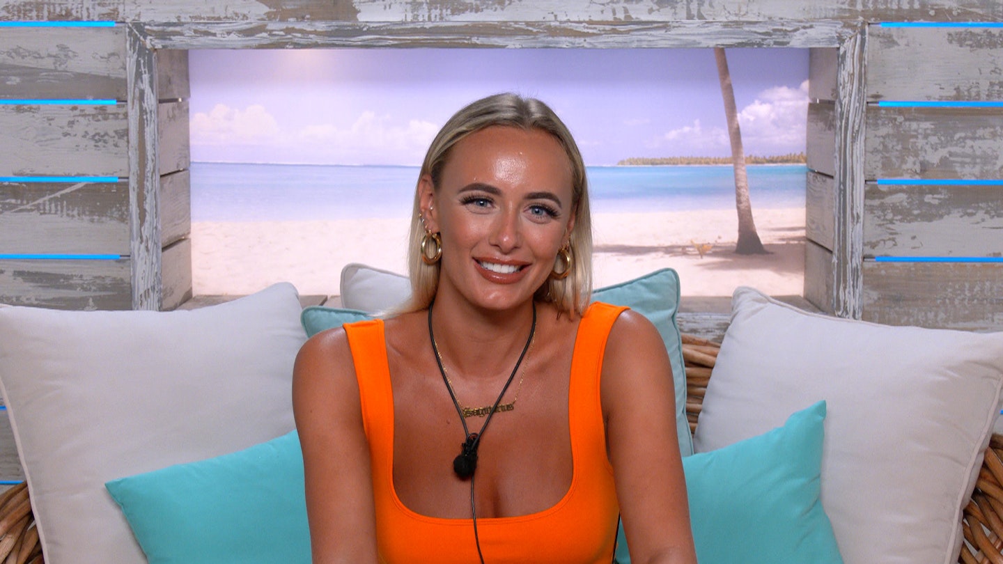 Millie Court wearing a gold star sign necklace on Love Island