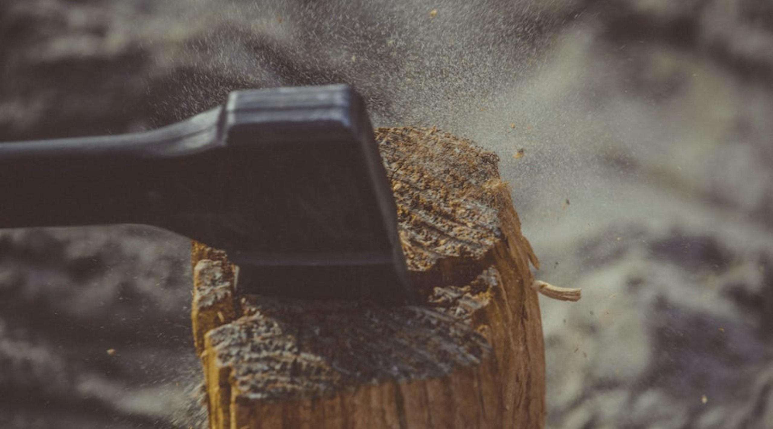 Close shot of axe splitting wood