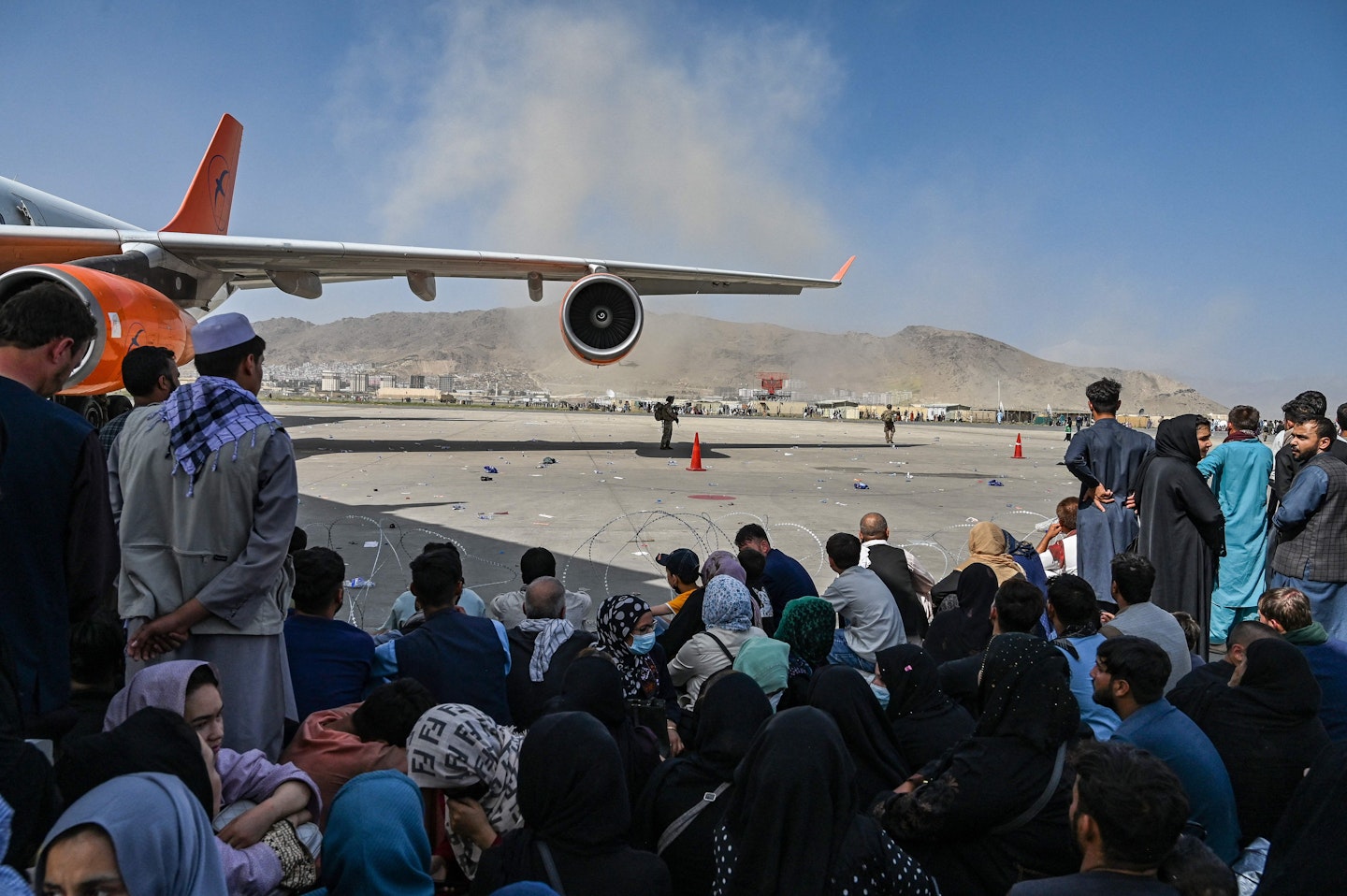 People attempt to flee Afghanistan at Kabul airport