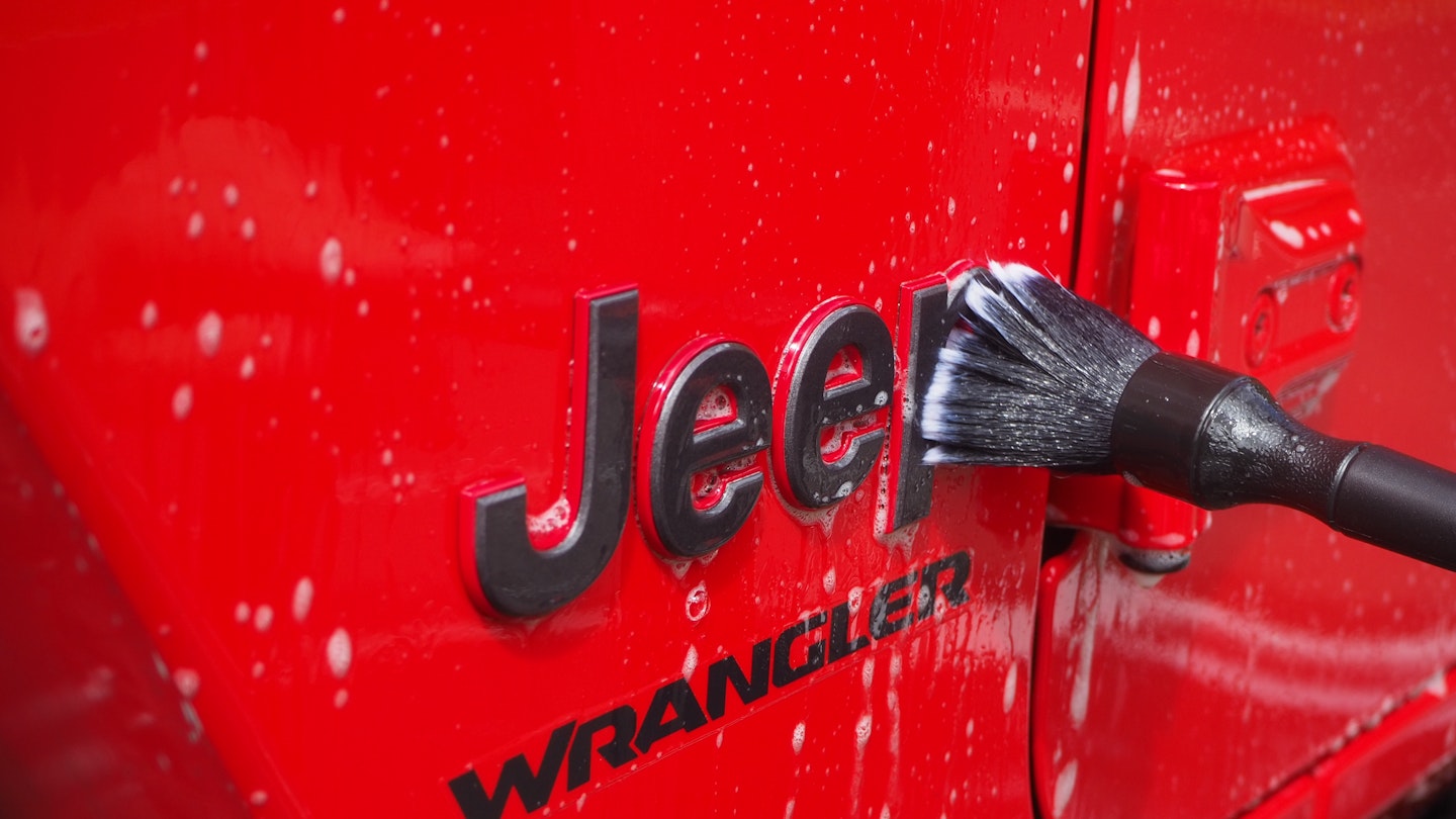 A detailing brush on the Jeep logo 