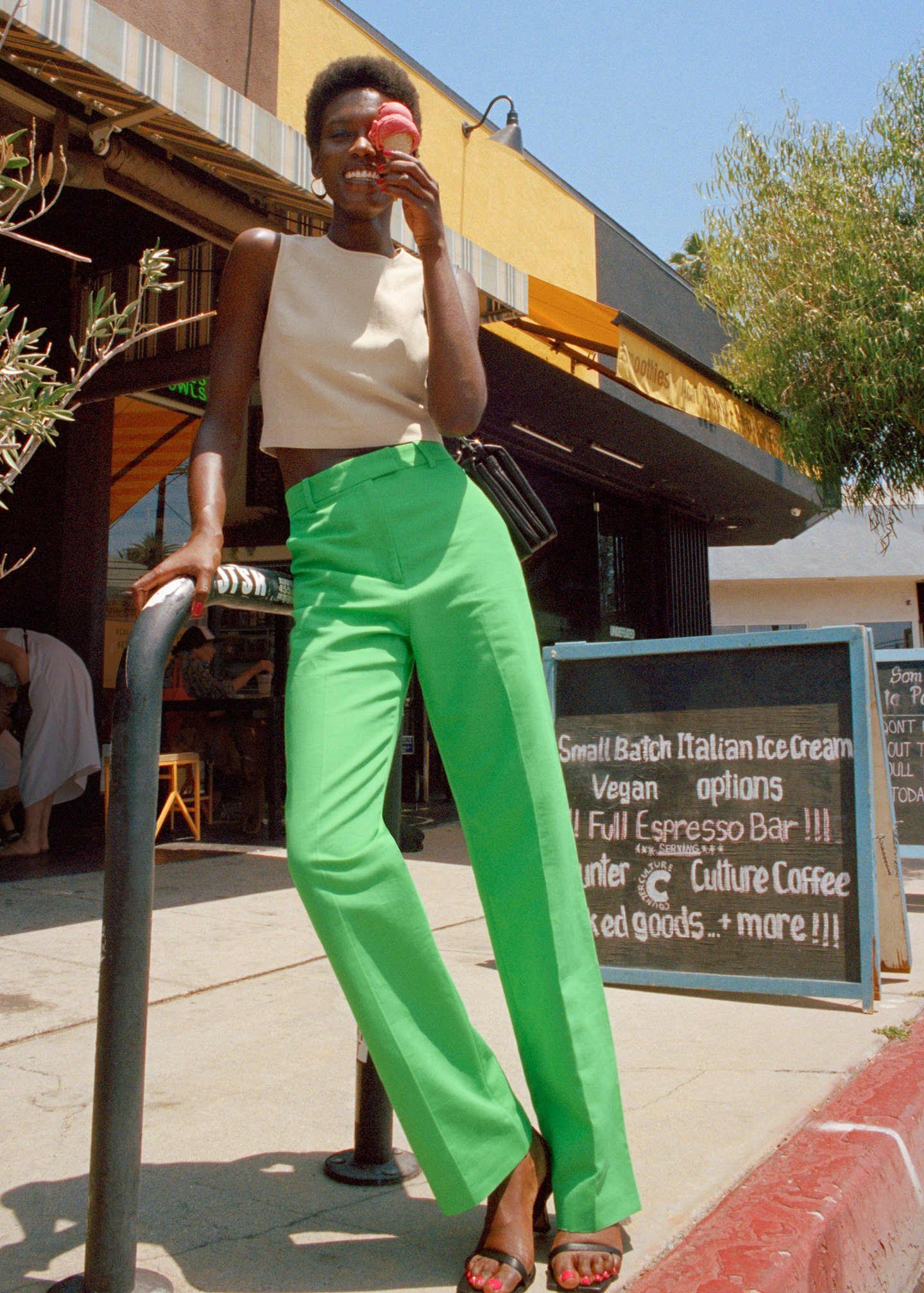 A model wearing bright green trousers from & Other Stories 