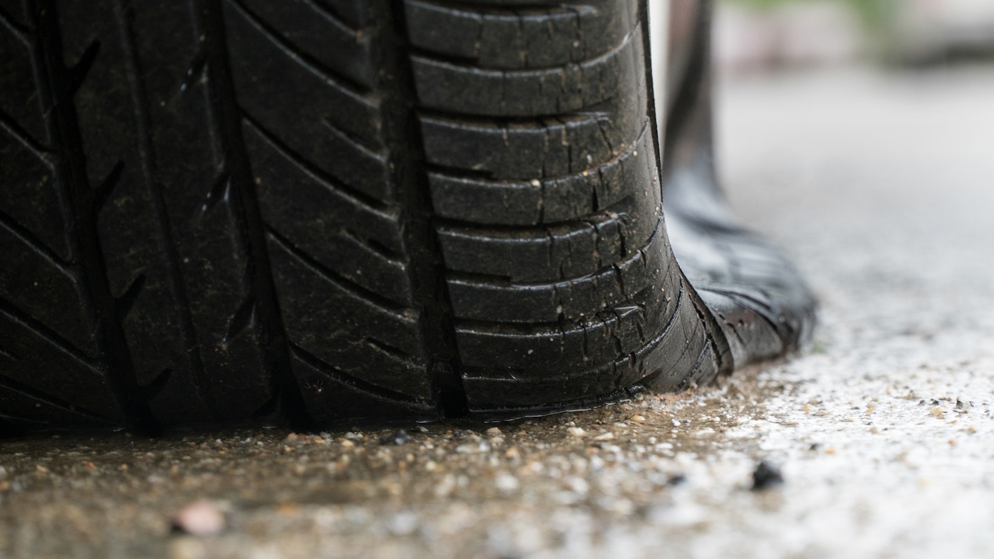 A close up of a flat car tyre
