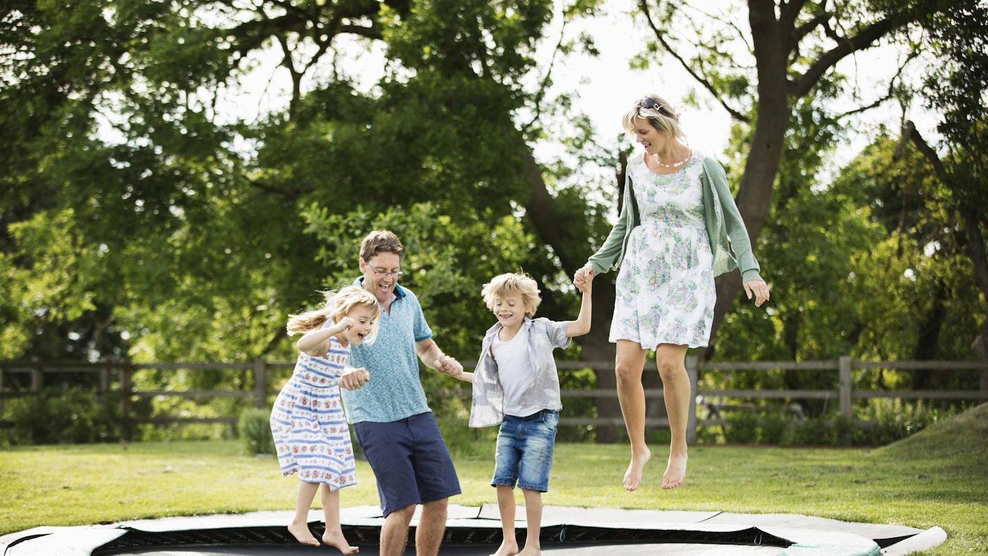 The best garden trampolines - family jumping on trampoline