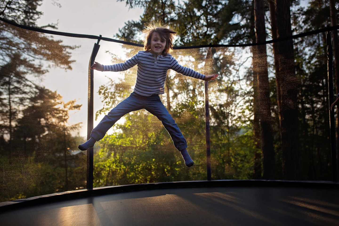 the best trampoline covers - boy jumping on trampoline