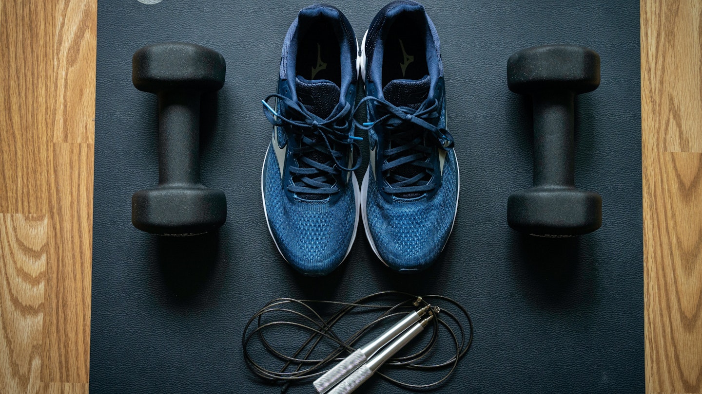 An image of gym trainers, dumbbells and a skipping rope