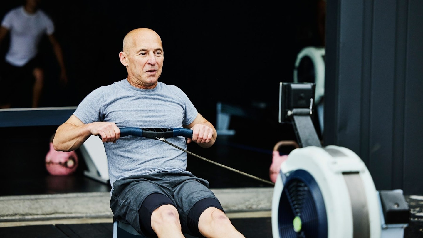Mature man working out on a rowing machine