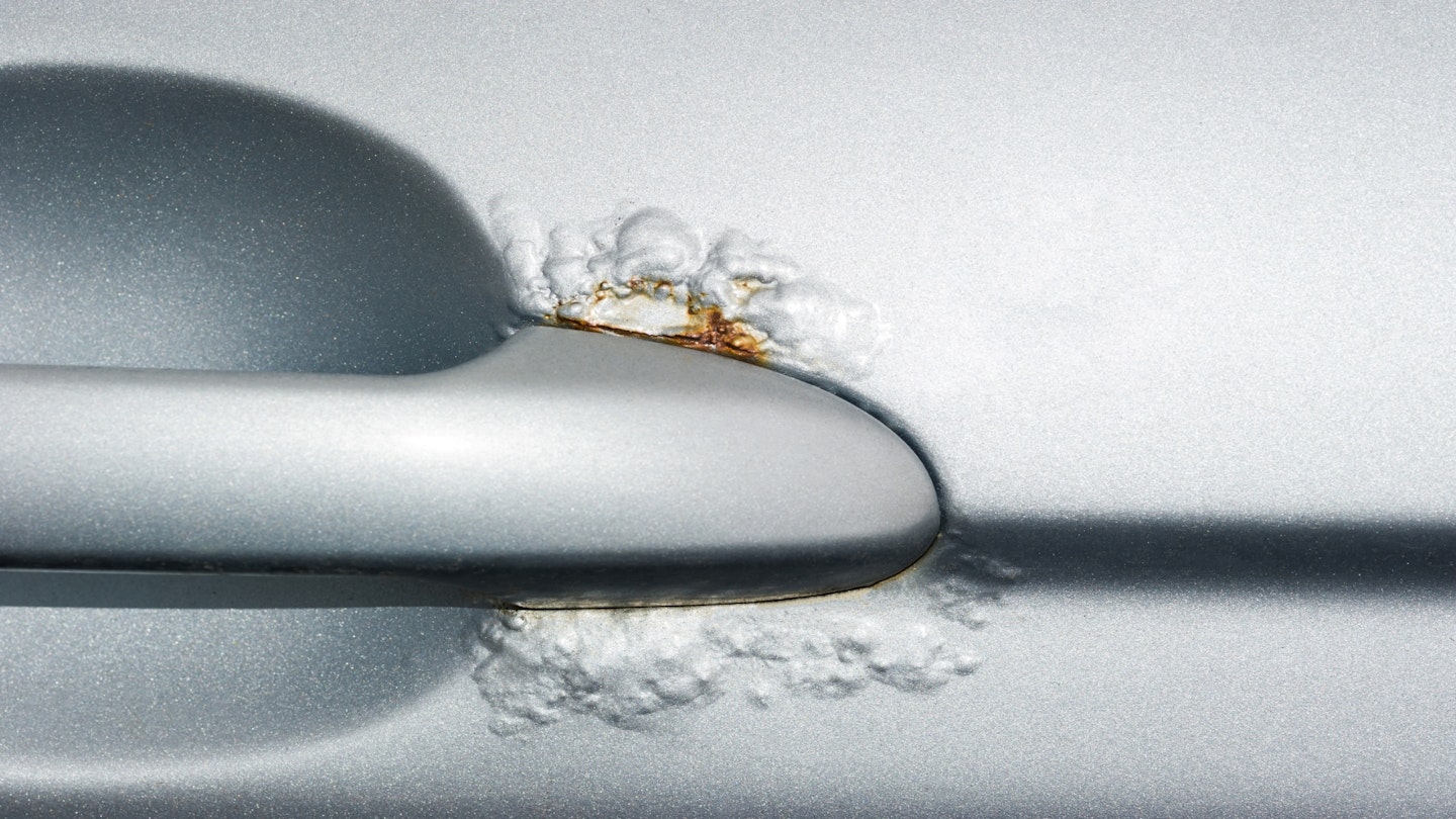 Bubbling paint around a car door handle