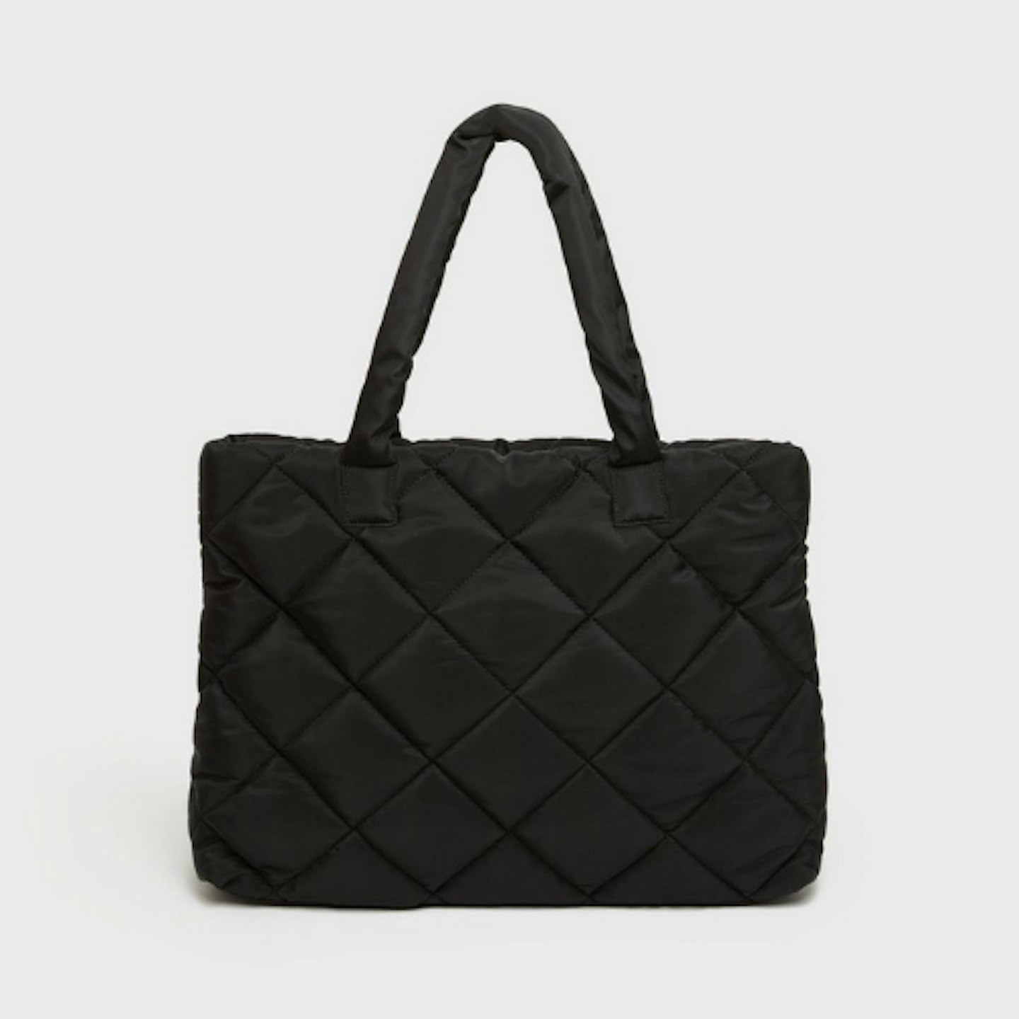 Black quilted bag on white background