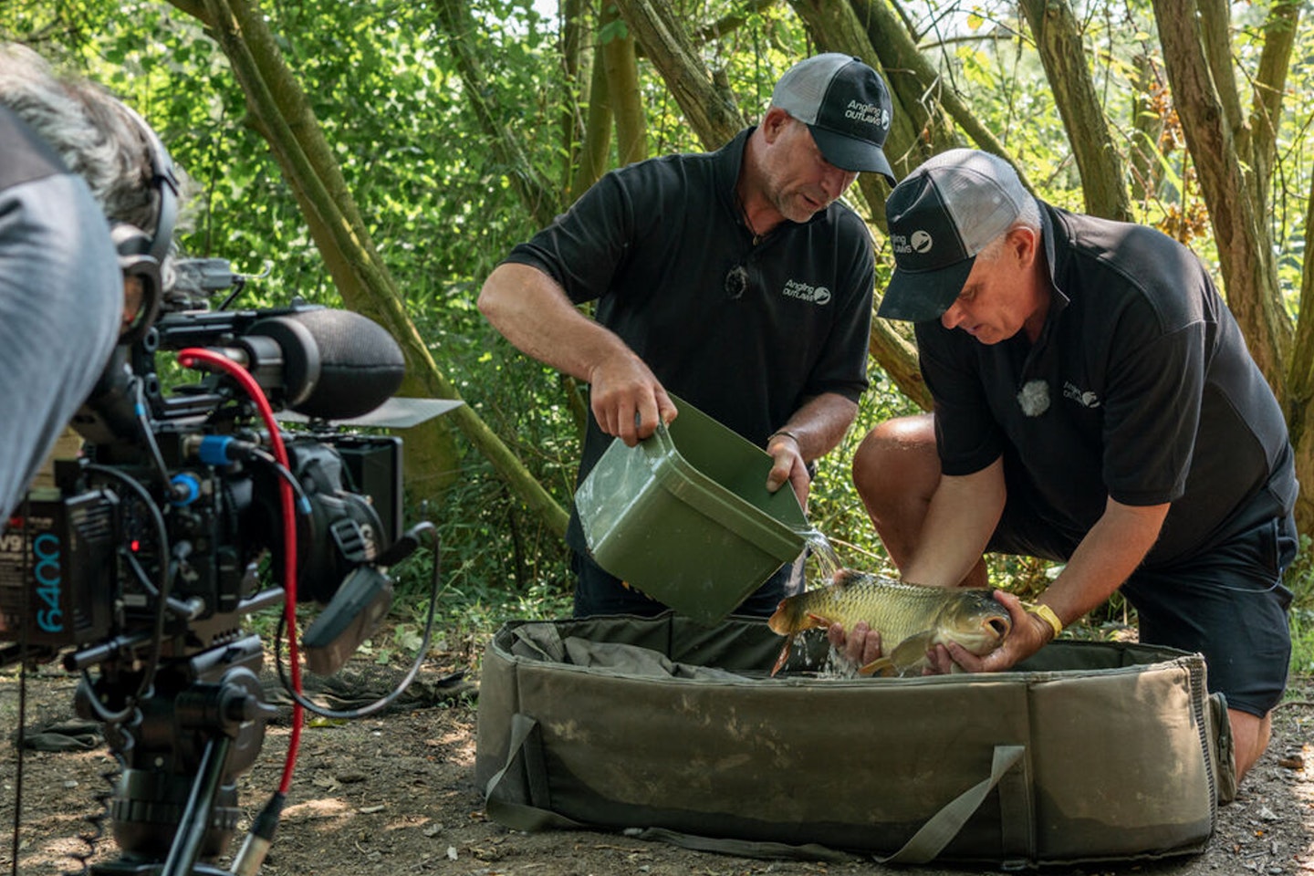 Nick Speed showing Tony Gale the importance of fish care