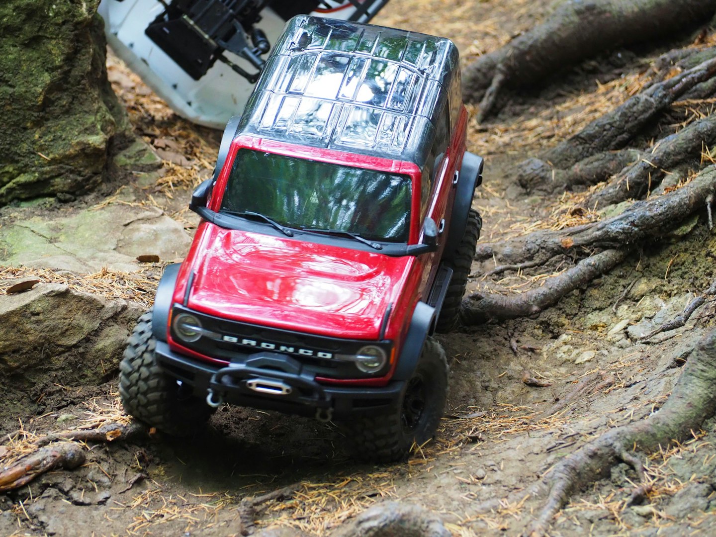 Traxxas Bronco going down a hill with Element Enduro rolling behind