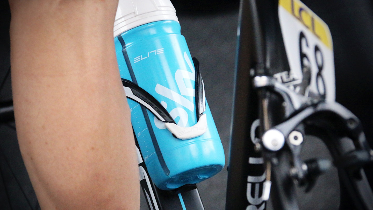 A water bottle being supported on a bicycle