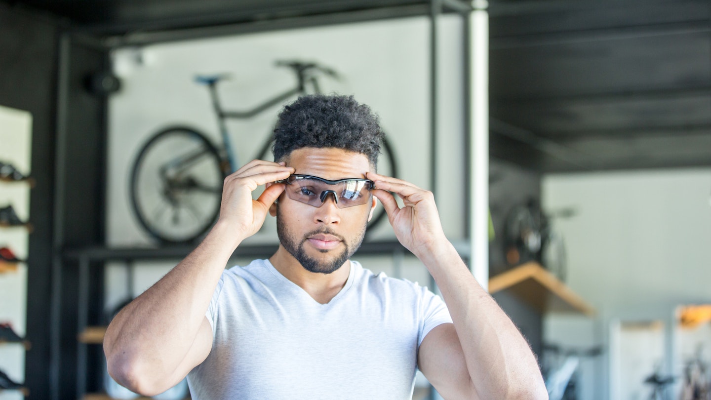 Man trying on cycling glasses