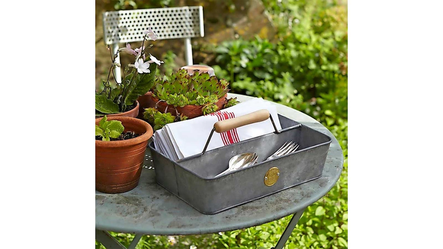 grey galvanised steel garden trug on a table with plants