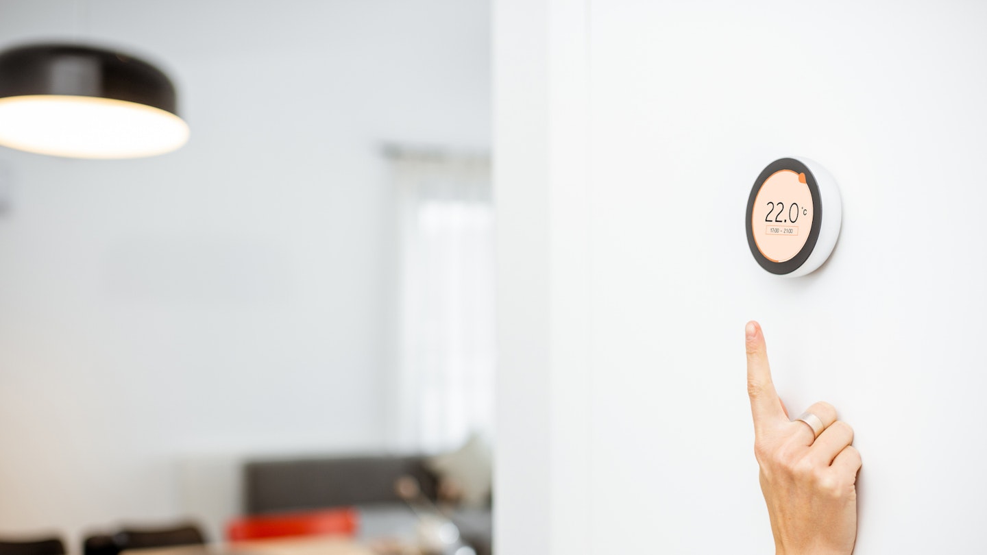 smart thermostat being pointed at