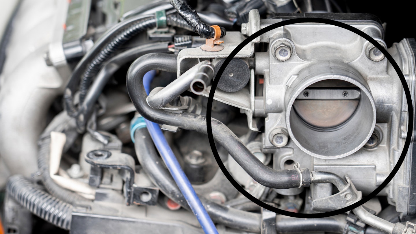 A throttle body in a car engine bay