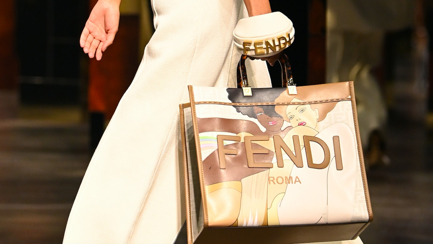A model carrying two bags from Fendi