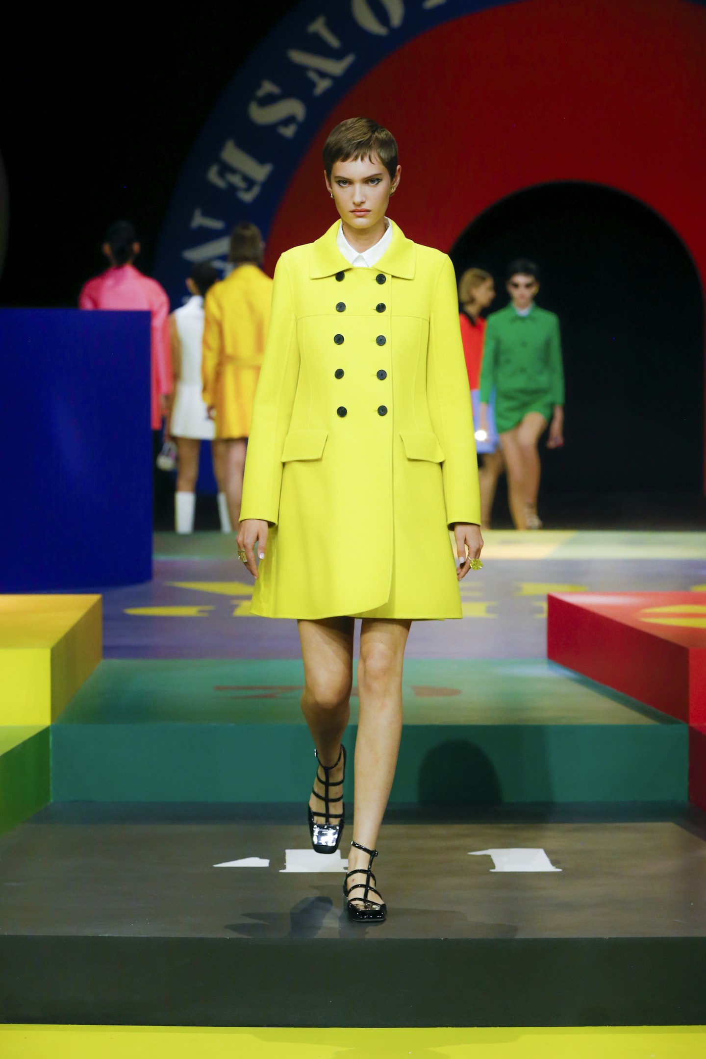 A model wearing a yellow coat from Dior