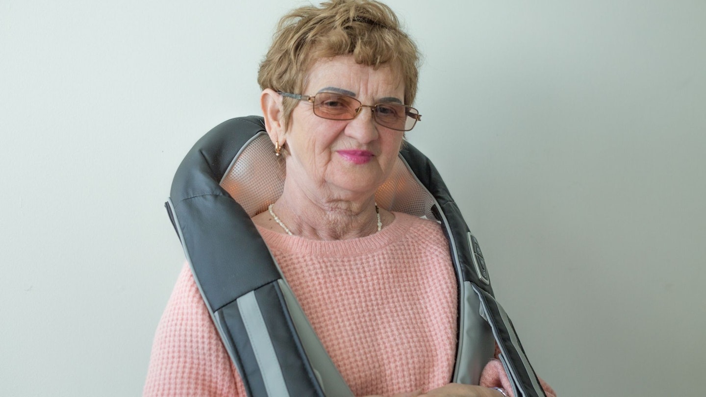 Senior woman with back massager
