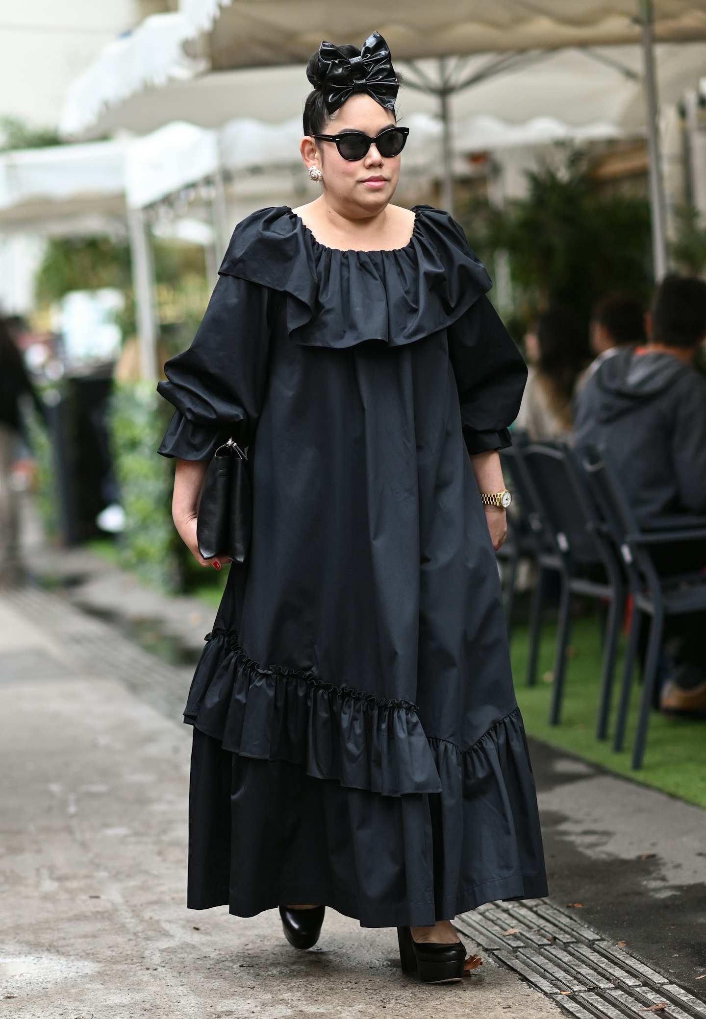 Katie Ruensumran matched her ruffled dress to her signature hair ribbon outside Rochas