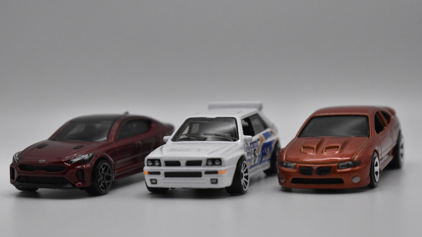 Three Hot Wheels models on a white background