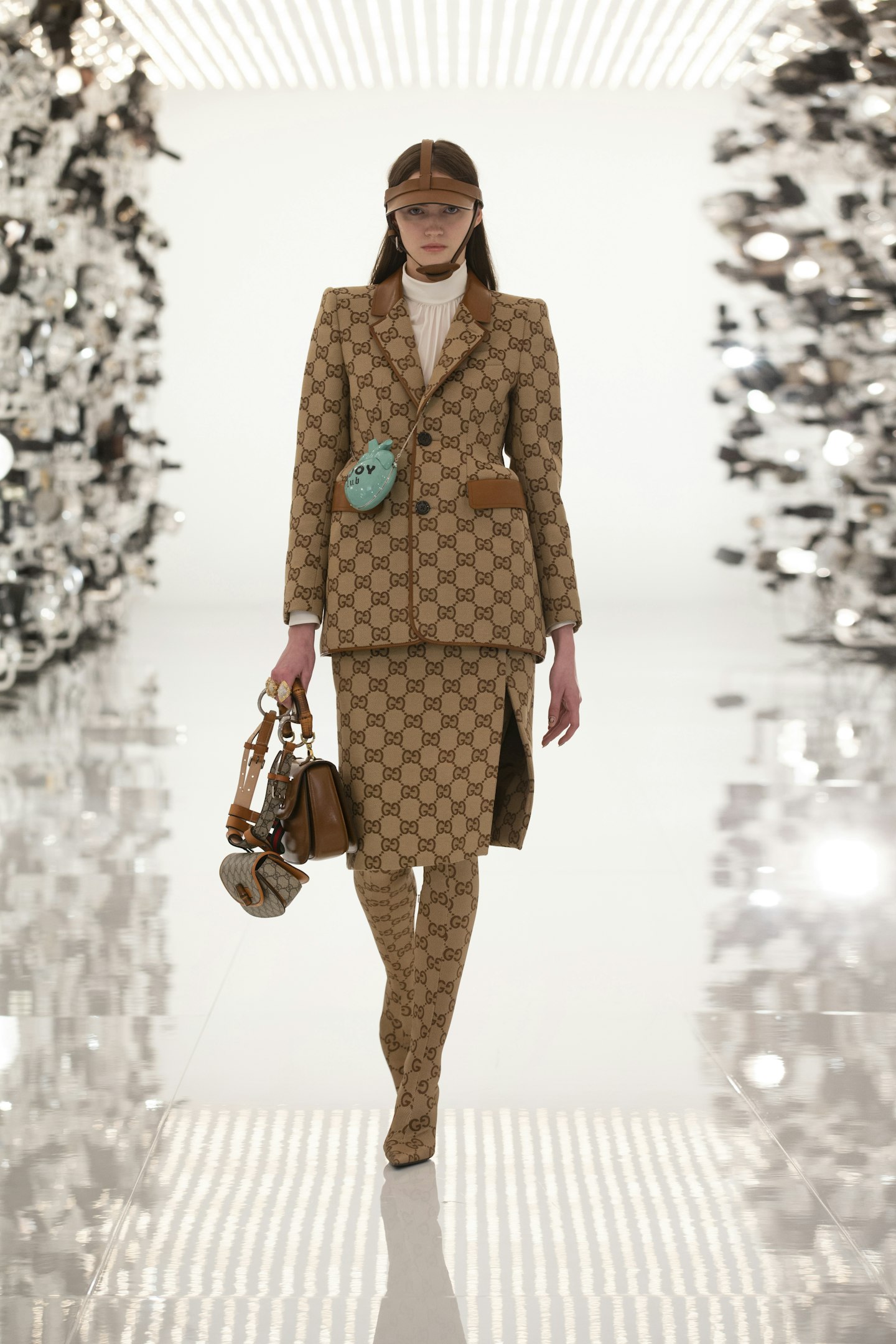 A model wearing a beige skirt suit as part of 'The Hacking Project' 
