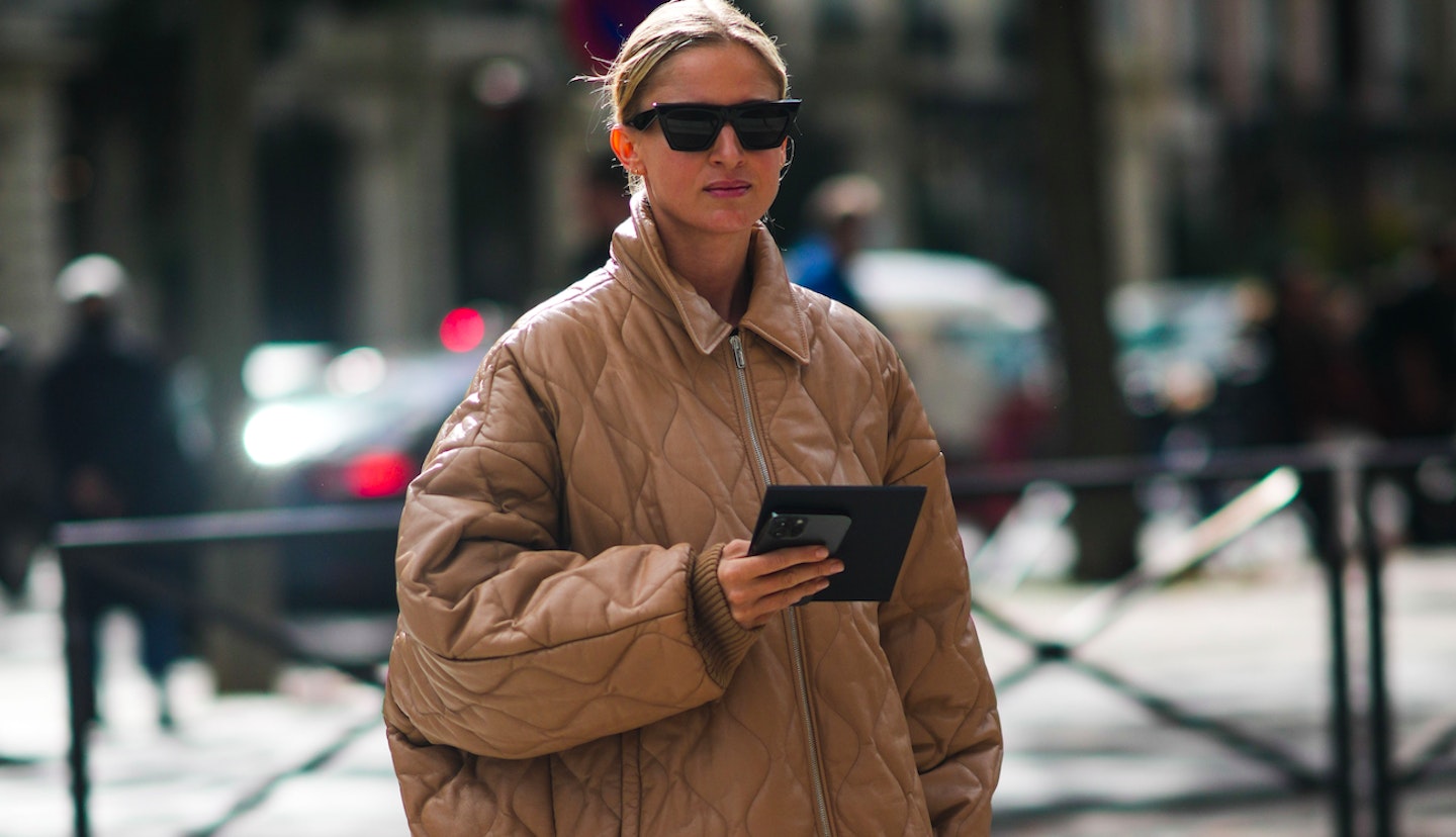 A street-styler wearing a quilted coat from PFW