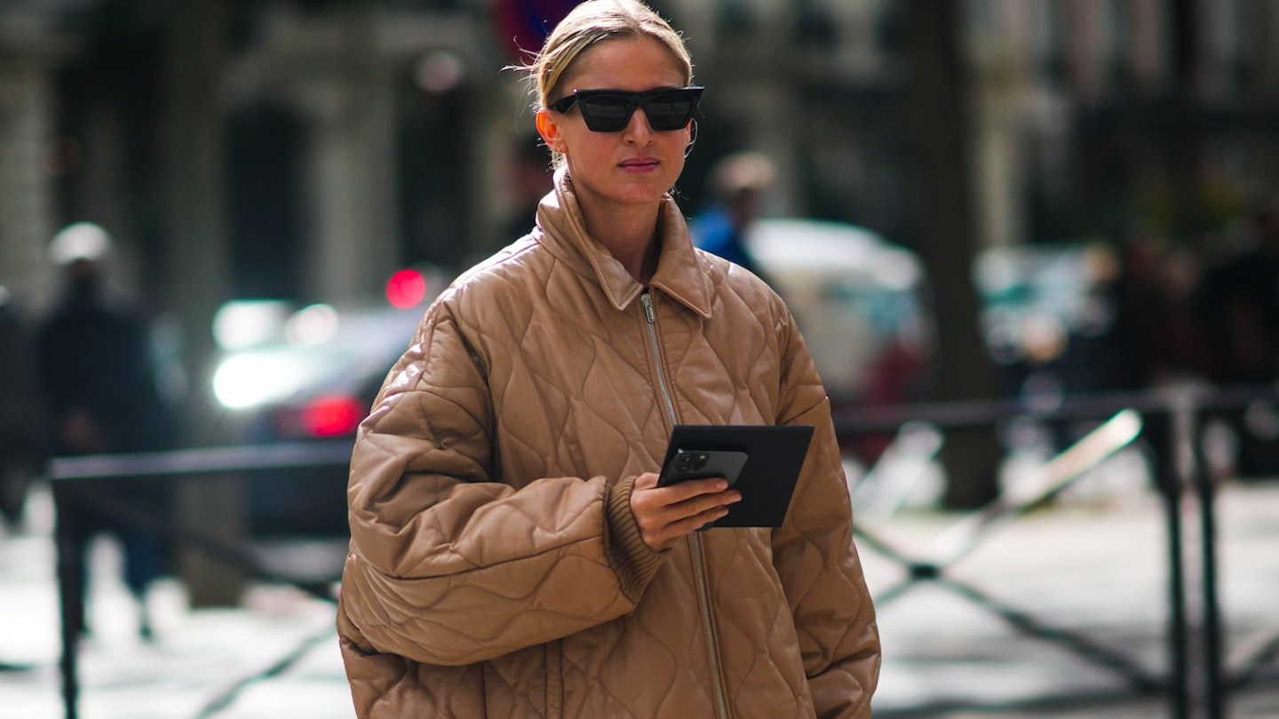A street-styler wearing a quilted coat from PFW