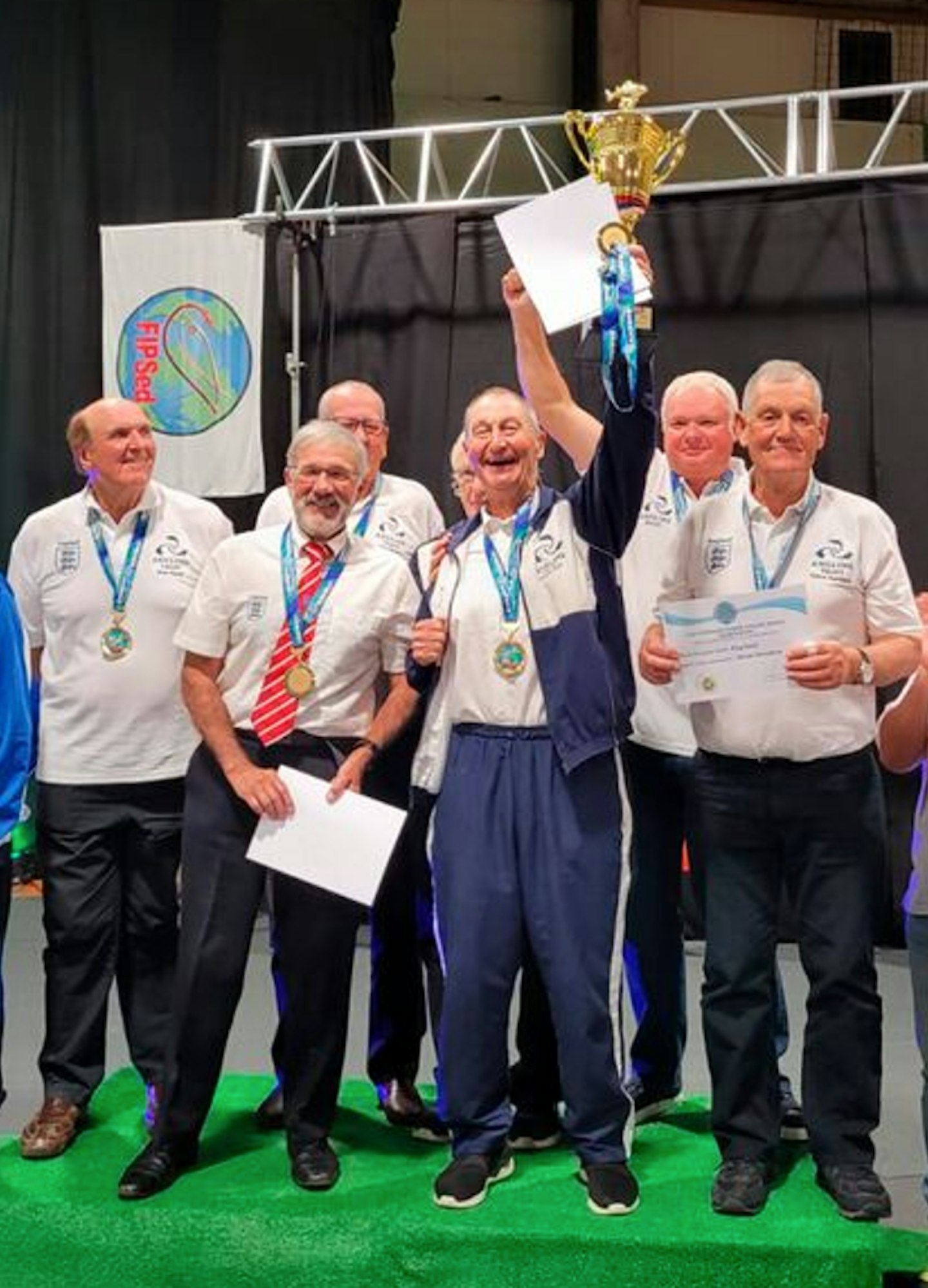 The team, with manager Dickie Carr holding the trophy, celebrate their world win