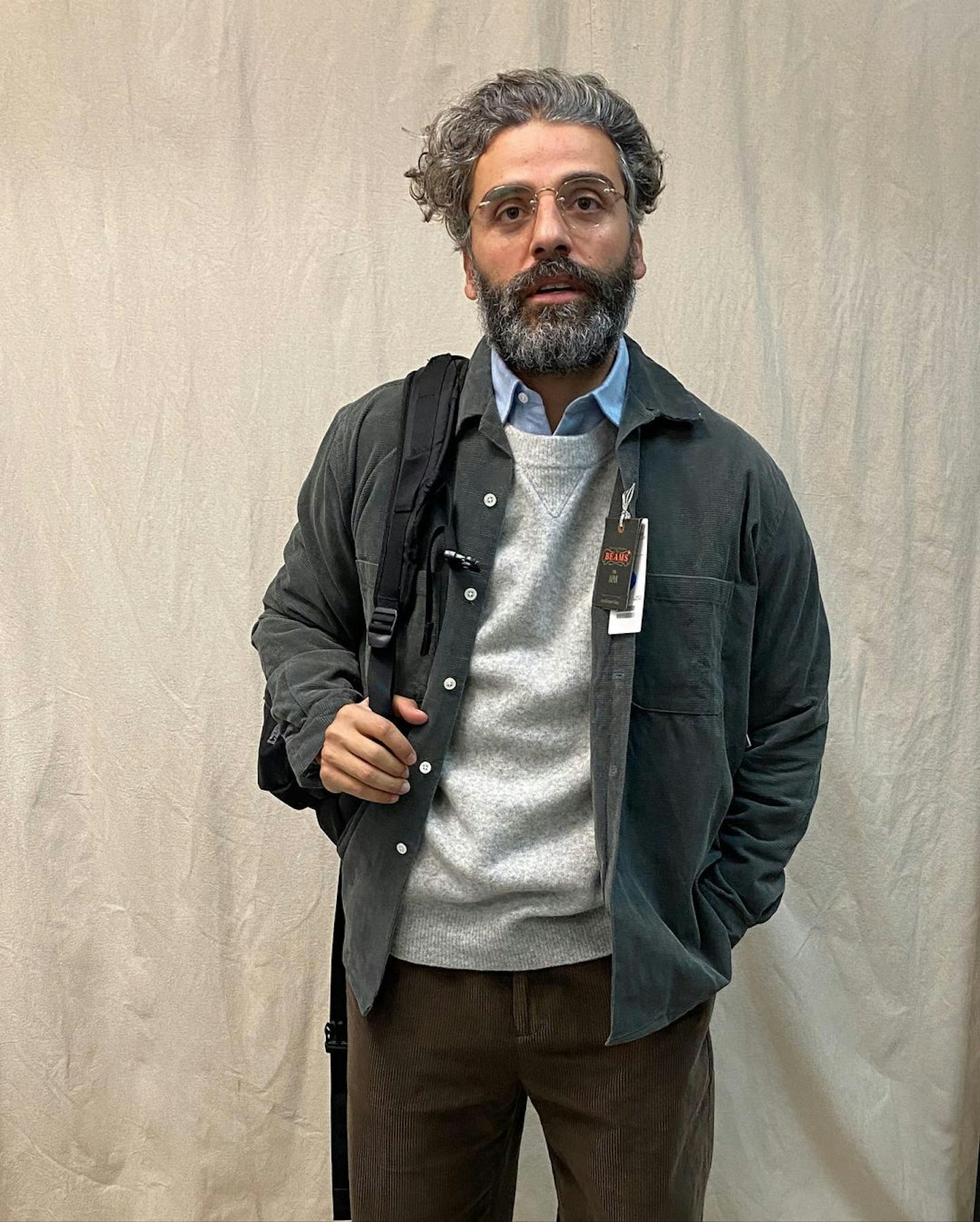 Oscar Issacs wearing a grey shacket 