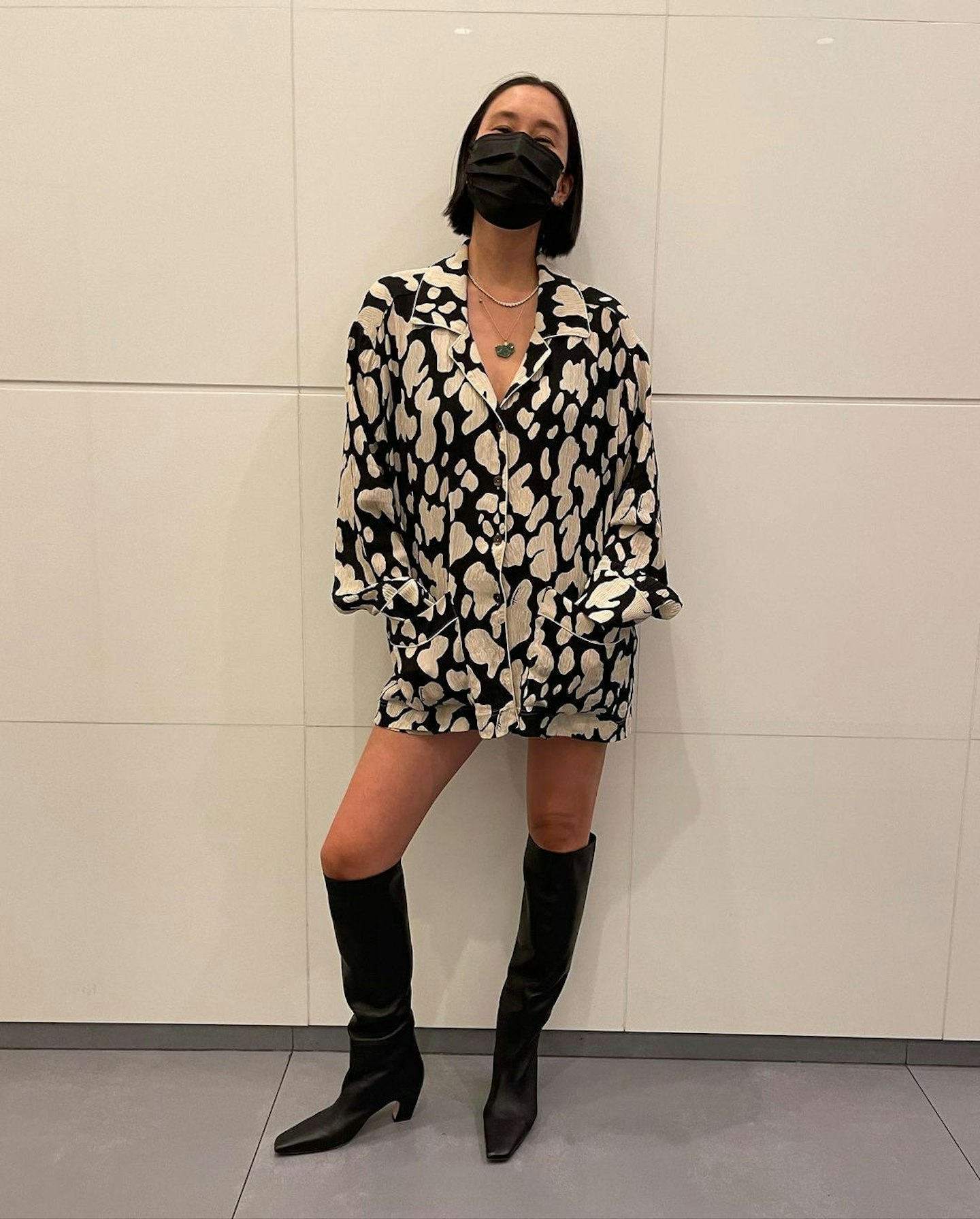Eva Chen wearing a minidress and knee-high boots