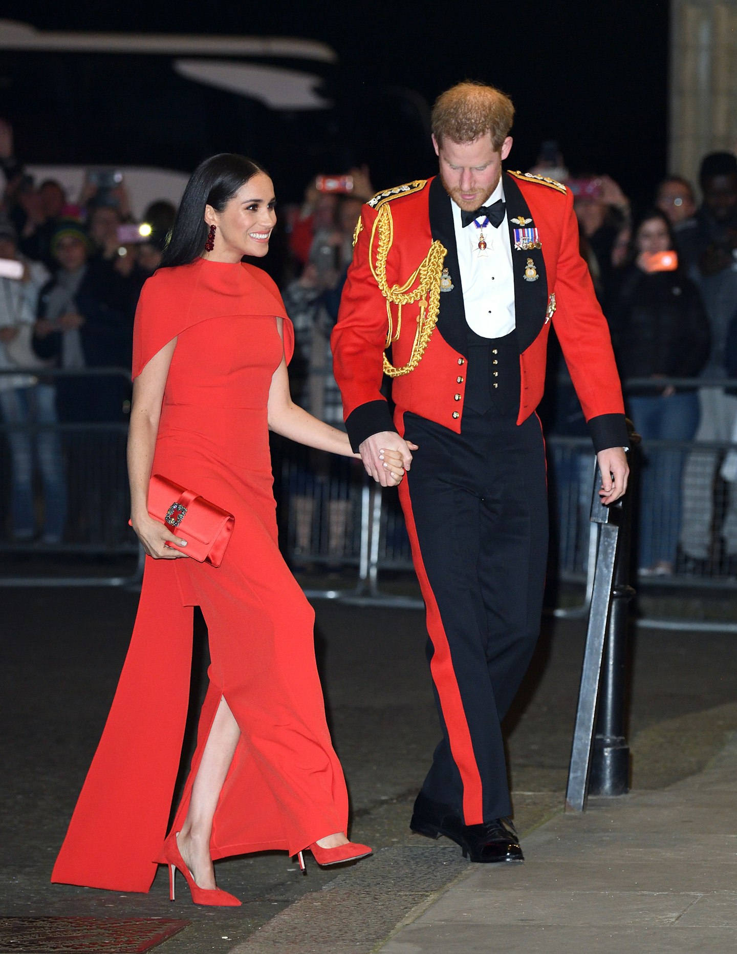 Meghan Markle wearing a red gown from Safiyaa