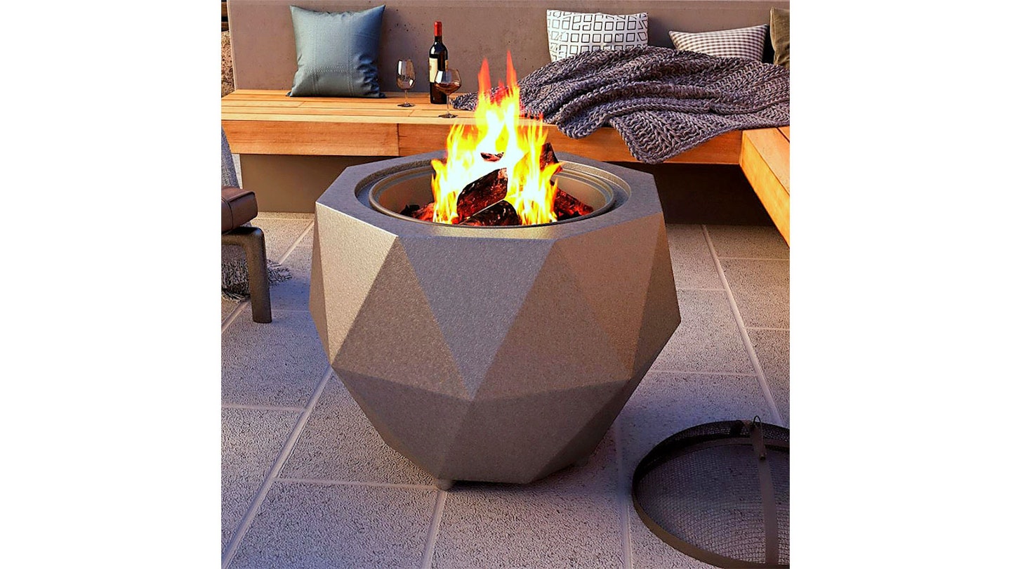 octagonal fire pit on patio with wine and blankets